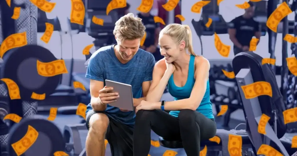 Coach and client smiling while reviewing a tablet, symbolizing Hexfit's return on investment